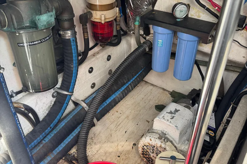 Dark And Stormy Yacht Photos Pics Engine compartment of a 2000 Tiara Yachts 3500 Express with filters and hoses visible.