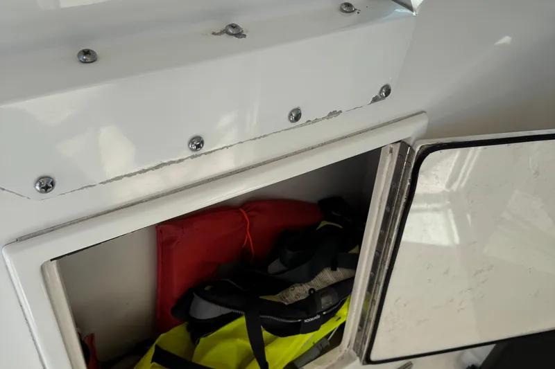 Dark And Stormy Yacht Photos Pics Open storage compartment on 2000 Tiara Yachts 3500 Express, containing life jackets and gear.