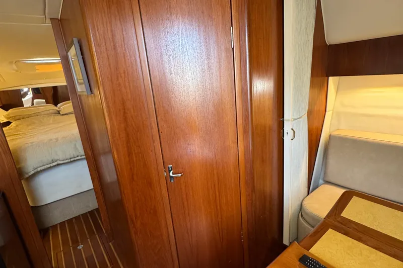 Dark And Stormy Yacht Photos Pics Interior of 2000 Tiara Yachts 3500 Express with wood paneling and cozy seating area.