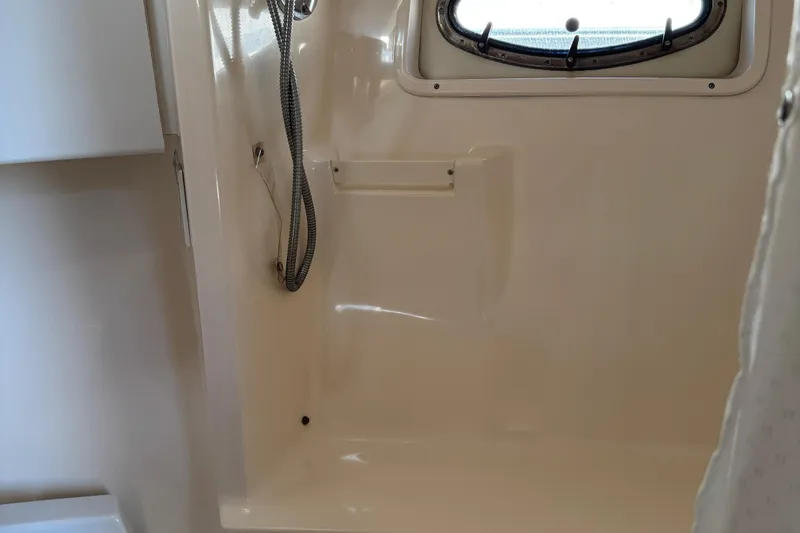 Dark And Stormy Yacht Photos Pics Interior shower area of a 2000 Tiara Yachts 3500 Express, featuring a sleek design.