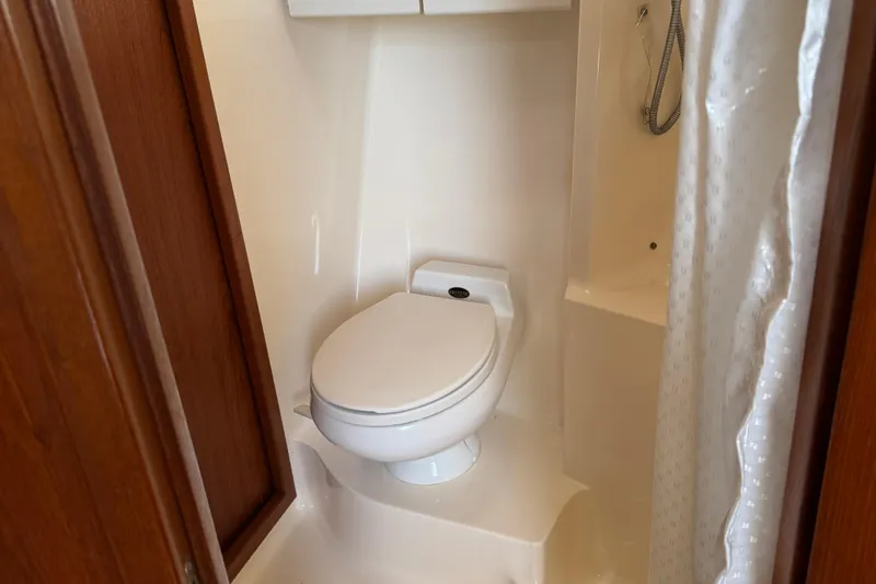 Dark And Stormy Yacht Photos Pics Bathroom interior of 2000 Tiara Yachts 3500 Express with toilet and shower.