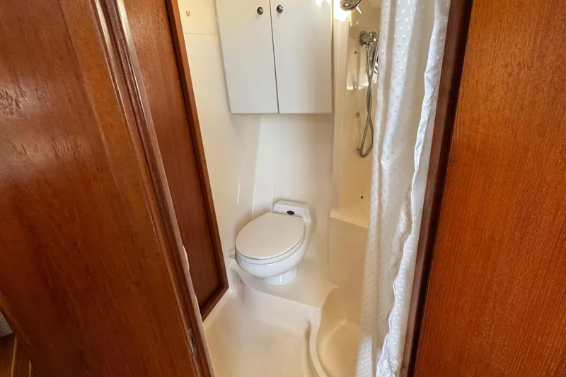 Dark And Stormy Yacht Photos Pics Bathroom interior of 2000 Tiara Yachts 3500 Express with shower and toilet.