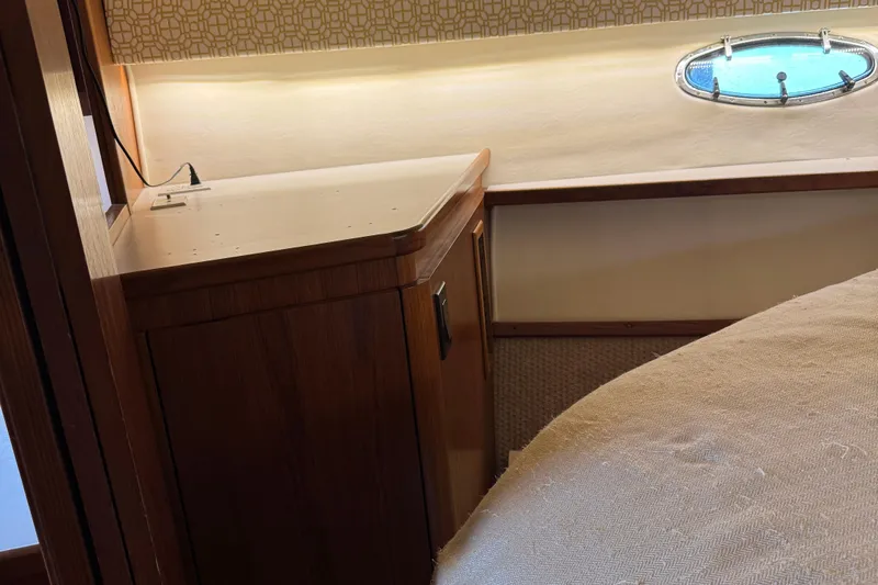 Dark And Stormy Yacht Photos Pics Interior of 2000 Tiara Yachts 3500 Express, featuring wood cabinetry and a porthole window.