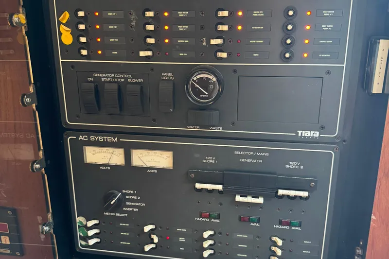 Dark And Stormy Yacht Photos Pics Control panel of a 2000 Tiara Yachts 3500 Express, featuring generator and AC system controls.