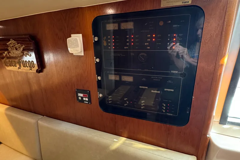 Dark And Stormy Yacht Photos Pics Control panel inside 2000 Tiara Yachts 3500 Express, featuring wood paneling and seating.