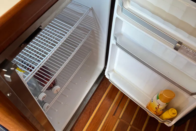 Dark And Stormy Yacht Photos Pics Open fridge on 2000 Tiara Yachts 3500 Express with drinks and condiments inside.