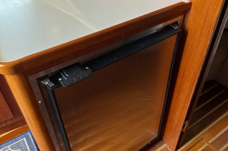 Dark And Stormy Yacht Photos Pics Wood-paneled interior of 2000 Tiara Yachts 3500 Express with built-in fridge.