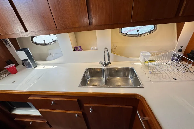 Dark And Stormy Yacht Photos Pics Interior of 2000 Tiara Yachts 3500 Express, featuring a well-equipped kitchen area.