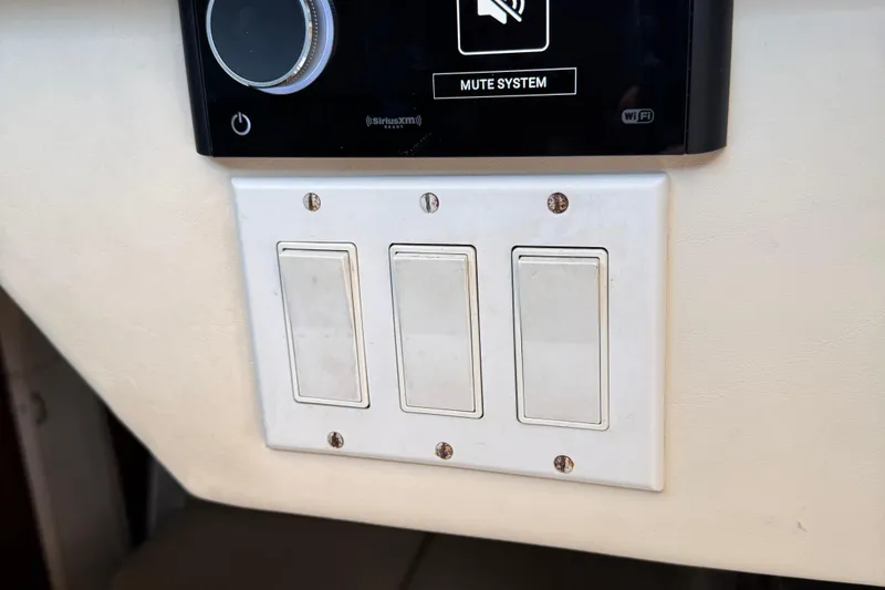 Dark And Stormy Yacht Photos Pics Control panel with three switches on a 2000 Tiara Yachts 3500 Express.
