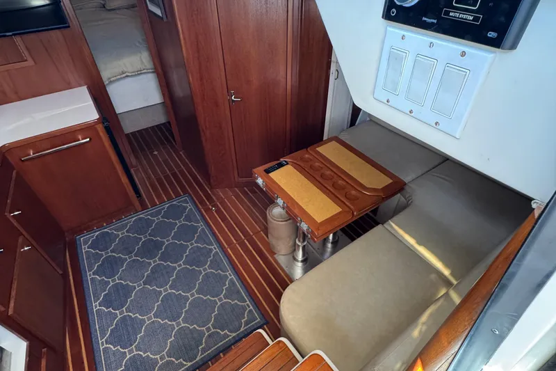 Dark And Stormy Yacht Photos Pics Interior of 2000 Tiara Yachts 3500 Express with wood accents and seating area.
