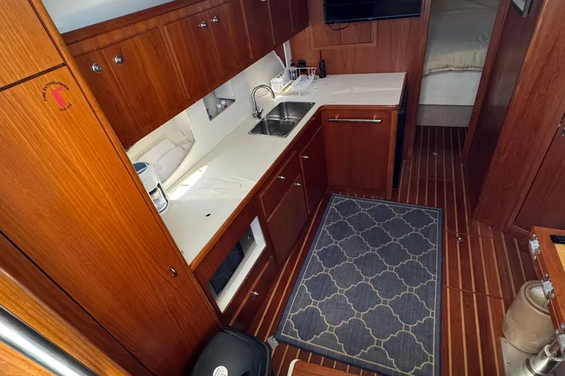 Dark And Stormy Yacht Photos Pics Interior of 2000 Tiara Yachts 3500 Express, featuring a wooden galley with modern amenities.