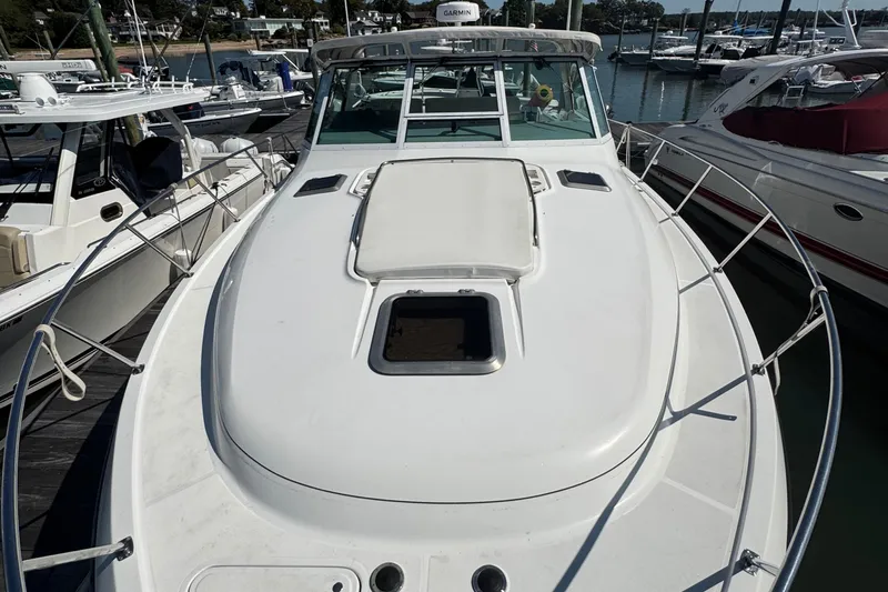 Dark And Stormy Yacht Photos Pics 2000 Tiara Yachts 3500 Express docked at marina, showcasing sleek deck design.