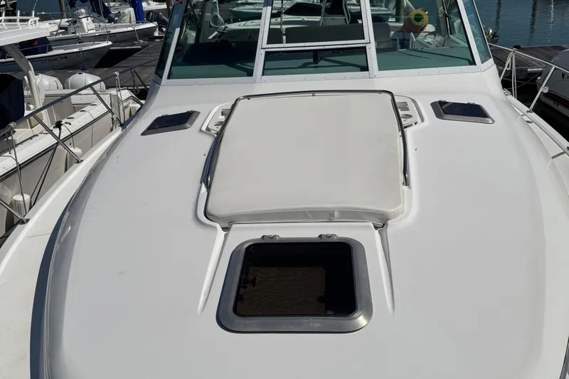 Dark And Stormy Yacht Photos Pics 2000 Tiara Yachts 3500 Express boat deck with open hatch, docked at marina.