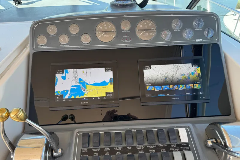 Dark And Stormy Yacht Photos Pics Control panel of a 2000 Tiara Yachts 3500 Express with Garmin navigation displays.
