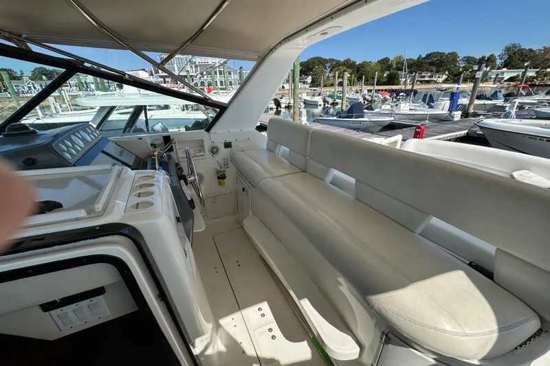 Dark And Stormy Yacht Photos Pics Interior view of 2000 Tiara Yachts 3500 Express, featuring helm and seating area at marina.