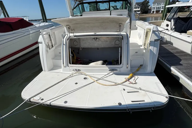 Dark And Stormy Yacht Photos Pics 2000 Tiara Yachts 3500 Express docked, rear view with open storage compartment.