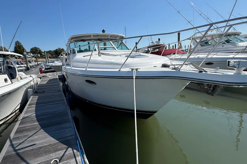 Dark And Stormy Yacht Photos Pics 2000 Tiara Yachts 3500 Express docked at marina under clear blue sky.