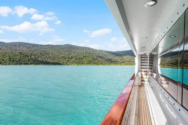 Batavia Yacht Photos Pics Side view of 2003 Richmond Yachts 135 Motor Yacht cruising on turquoise waters.