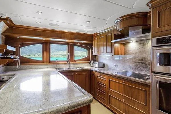 Batavia Yacht Photos Pics Luxurious kitchen interior of 2003 Richmond Yachts 135 Motor Yacht with wood cabinetry and modern appliances.