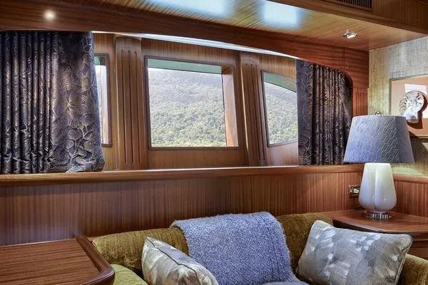 Batavia Yacht Photos Pics Luxurious interior of 2003 Richmond Yachts 135 Motor Yacht with elegant wood paneling and plush seating.