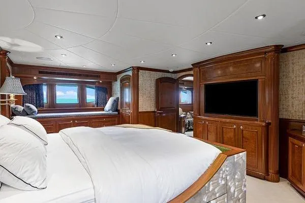 Batavia Yacht Photos Pics Luxurious bedroom interior of 2003 Richmond Yachts 135 Motor Yacht with wood paneling and large windows.