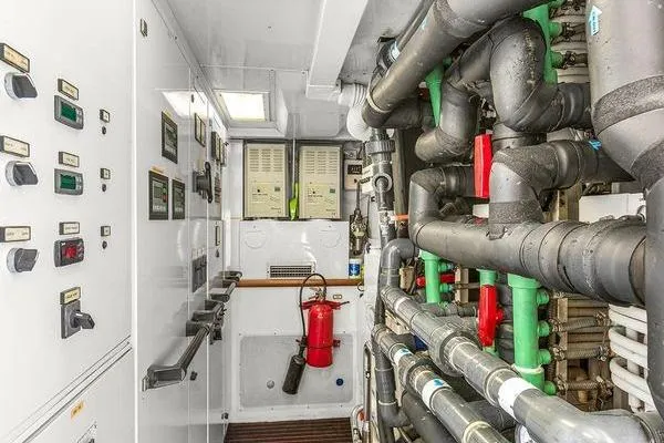 Batavia Yacht Photos Pics Engine room of 2003 Richmond Yachts 135 Motor Yacht with control panels and piping.