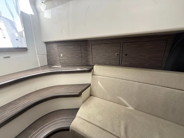  Yacht Photos Pics Interior of 2017 Boston Whaler 420 Outrage, featuring sleek wood paneling and beige seating.