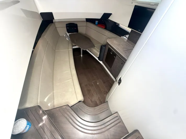  Yacht Photos Pics Interior cabin of 2017 Boston Whaler 420 Outrage, featuring seating and a small table.