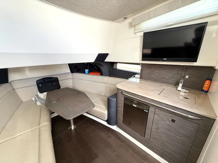  Yacht Photos Pics Interior of 2017 Boston Whaler 420 Outrage, featuring a cozy seating area and kitchenette.