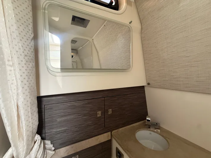 Yacht Photos Pics Interior of 2017 Boston Whaler 420 Outrage bathroom with mirror and sink.