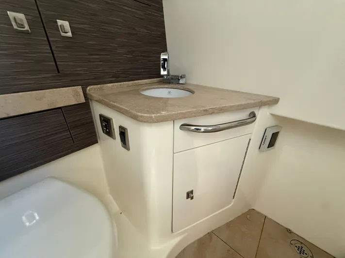  Yacht Photos Pics 2017 Boston Whaler 420 Outrage bathroom with modern sink and cabinetry.