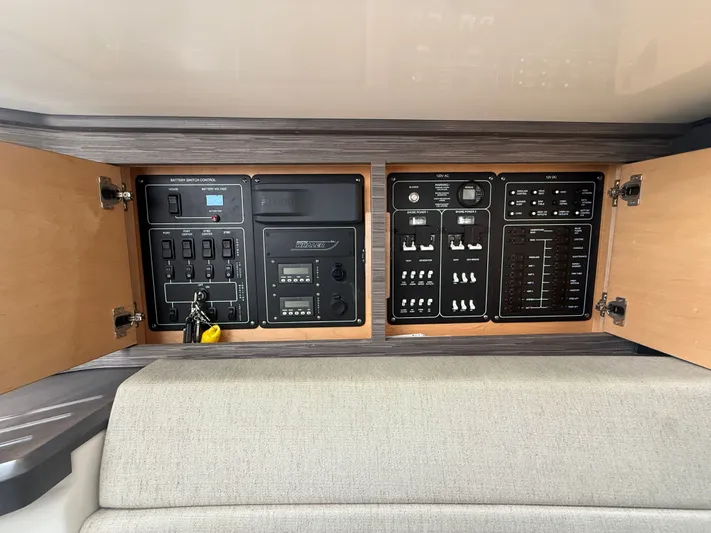  Yacht Photos Pics Control panel of a 2017 Boston Whaler 420 Outrage boat, featuring switches and gauges.