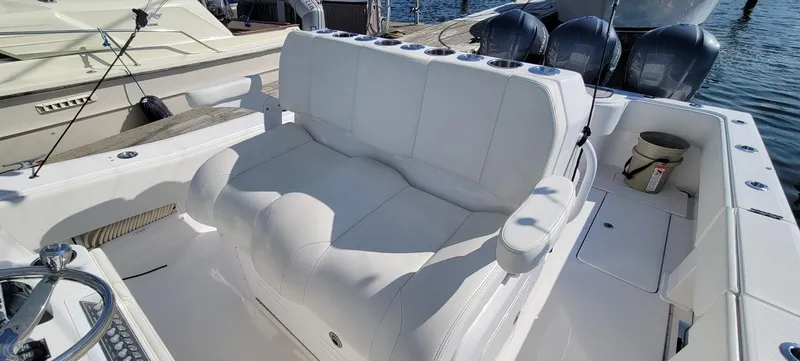End Game Yacht Photos Pics 2020 Invincible 36 CC boat interior with white seating and triple outboard engines.