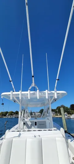 End Game Yacht Photos Pics 2020 Invincible 36 CC boat with fishing rods, clear blue sky background.