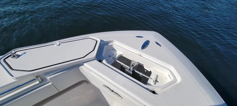 End Game Yacht Photos Pics Bow of 2020 Invincible 36 CC boat with open storage compartment on water.