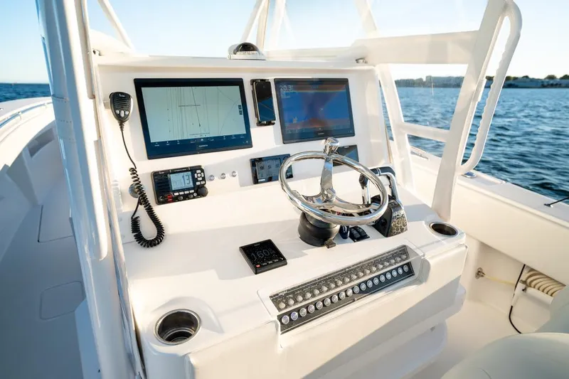 End Game Yacht Photos Pics Invincible 36 CC 2020 boat dashboard with modern navigation equipment and steering wheel.