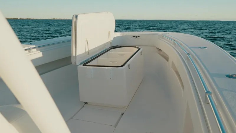 End Game Yacht Photos Pics 2020 Invincible 36 CC boat interior with open storage compartment on calm sea.