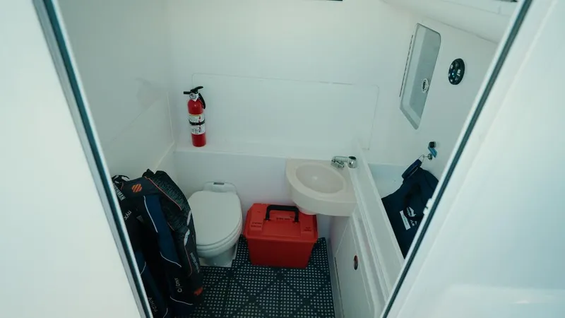 End Game Yacht Photos Pics Interior of 2020 Invincible 36 CC boat bathroom with toilet, sink, and fire extinguisher.