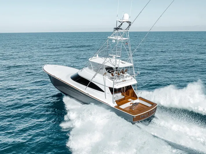 Bid Time Yacht Photos Pics 2023 Viking 72 Convertible yacht cruising on open sea.