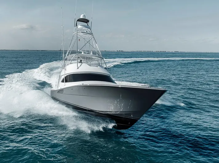 Bid Time Yacht Photos Pics 2023 Viking 72 Convertible yacht cruising on open water.