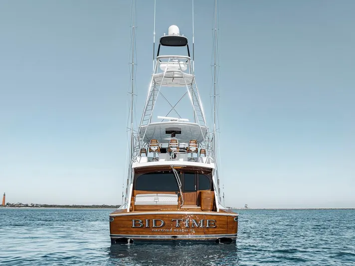 Bid Time Yacht Photos Pics 2023 Viking 72 Convertible yacht on calm sea, rear view.