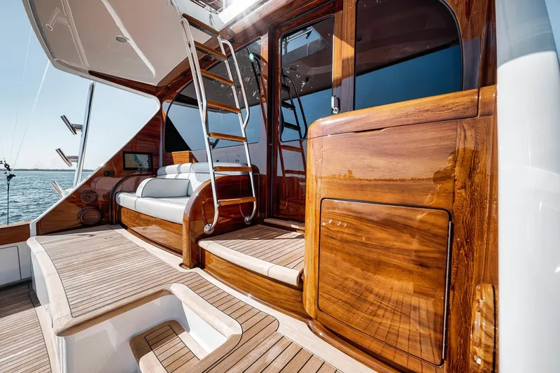 Bid Time Yacht Photos Pics Luxurious 2023 Viking 72 Convertible yacht interior with polished wood and elegant seating.