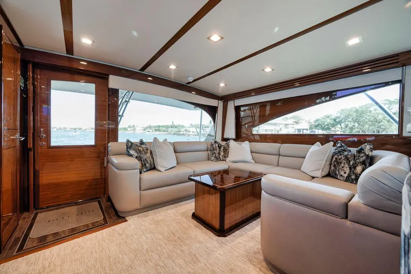 Bid Time Yacht Photos Pics Luxurious interior of 2023 Viking 72 Convertible yacht with plush seating and elegant decor.