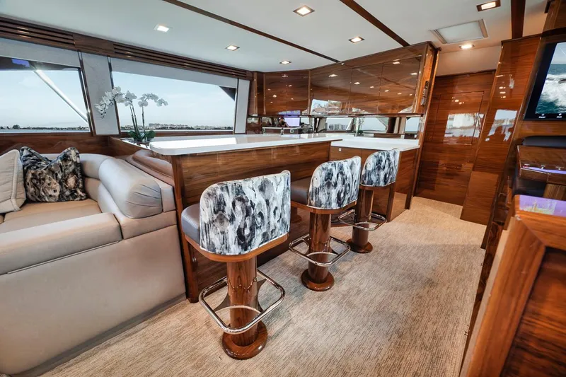 Bid Time Yacht Photos Pics Luxurious interior of 2023 Viking 72 Convertible yacht with elegant seating and modern design.
