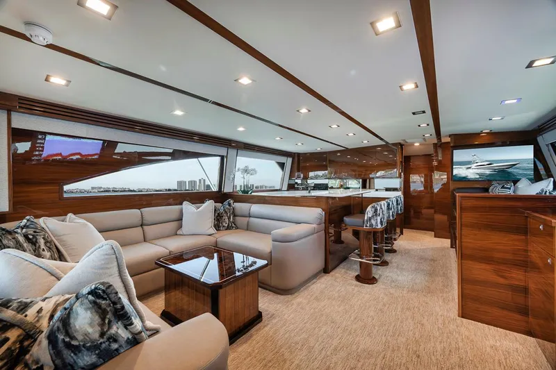 Bid Time Yacht Photos Pics Luxurious interior of 2023 Viking 72 Convertible yacht with plush seating and elegant wood finishes.