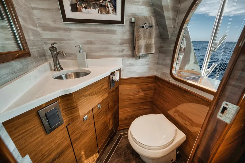 Bid Time Yacht Photos Pics Luxurious bathroom interior of 2023 Viking 72 Convertible yacht with ocean view.