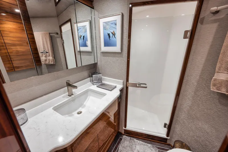 Bid Time Yacht Photos Pics Luxurious bathroom in 2023 Viking 72 Convertible yacht with modern fixtures and elegant design.