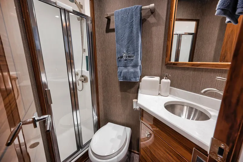 Bid Time Yacht Photos Pics Luxury bathroom in 2023 Viking 72 Convertible yacht with modern fixtures and elegant design.