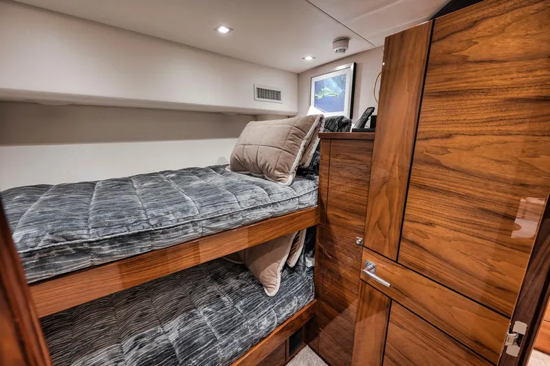 Bid Time Yacht Photos Pics 2023 Viking 72 Convertible yacht interior with wooden bunk beds and modern design.