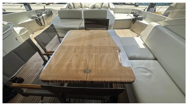  Yacht Photos Pics Luxury seating area on 2009 Azimut 68S yacht with wooden table and cushioned chairs.